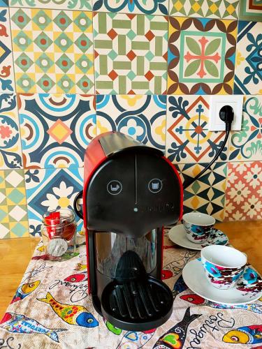 a coffee maker sitting on top of a table at Seixal Bay Village - Estúdio Vista Piscina in Seixal
