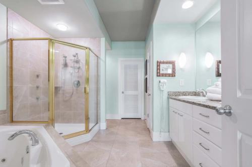 a white bathroom with a shower and a sink at Caribe Resort Unit C1108 in Orange Beach