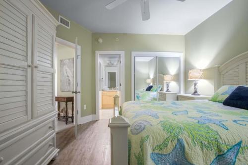 a bedroom with a large bed with a colorful bedspread at Caribe Resort Unit C1108 in Orange Beach