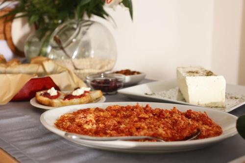 a table with a plate of food on a table at Artina Nuovo in Marathopolis