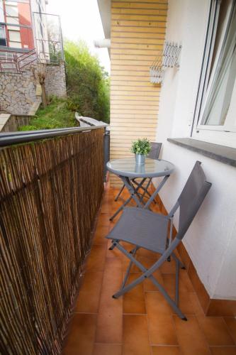 a small table and a chair on a balcony at Etxeberri EBI01805 in Ermua