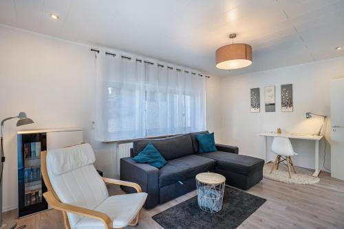a living room with a couch and a chair at Ferienwohnung Drachenstein in Weinheim