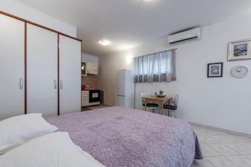 a bedroom with a large bed and a table at Apartment Italia in Dubrovnik
