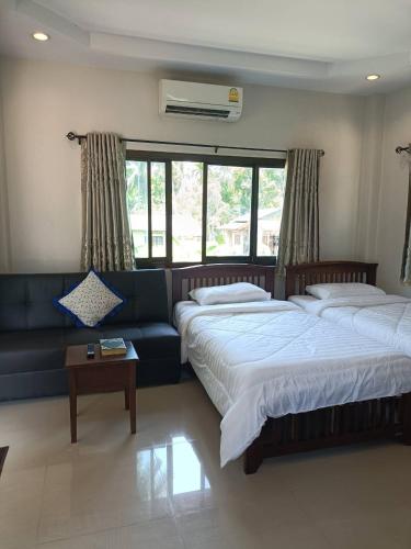 a living room with two beds and a couch at Wasin House One Bedroom - Maenum in Mae Nam
