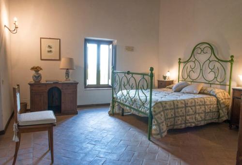 a bedroom with a green bed and a fireplace at Agriturismo Piano Grande in Avigliano