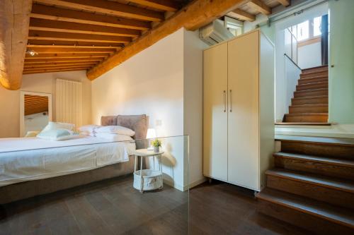 ein Schlafzimmer mit einem Bett und einer Treppe in der Unterkunft Appartamento Stella - Verona Centro in Verona