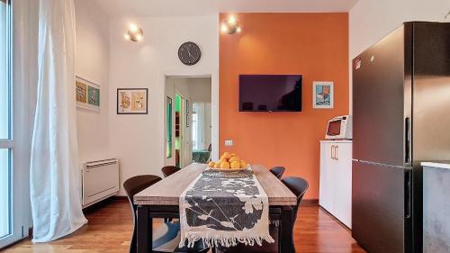 a dining room with a table and a refrigerator at Il Passatore in Forlì