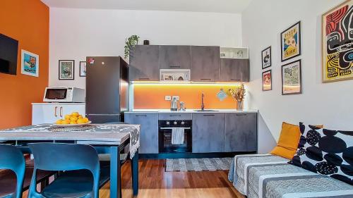 a kitchen with a table and a kitchen with a sink at Il Passatore in Forlì