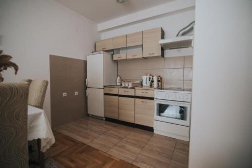 a kitchen with a white refrigerator and a stove at Apartment Peckham in Trebinje