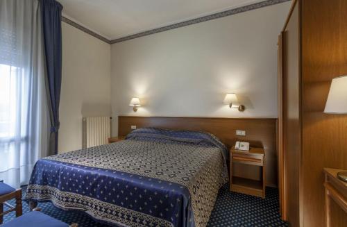 Postel nebo postele na pokoji v ubytování Hotel Firenze
