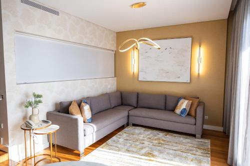 a living room with a couch and a table at Pestana Cidadela Cascais - Pousada & Art District in Cascais