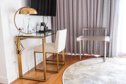 a desk with a white chair and a mirror at Pestana Cidadela Cascais - Pousada & Art District in Cascais