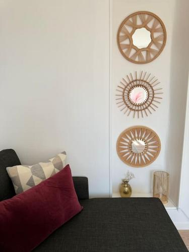 a room with a bed and two mirrors on the wall at Appartement aux portes de Paris in Ivry-sur-Seine
