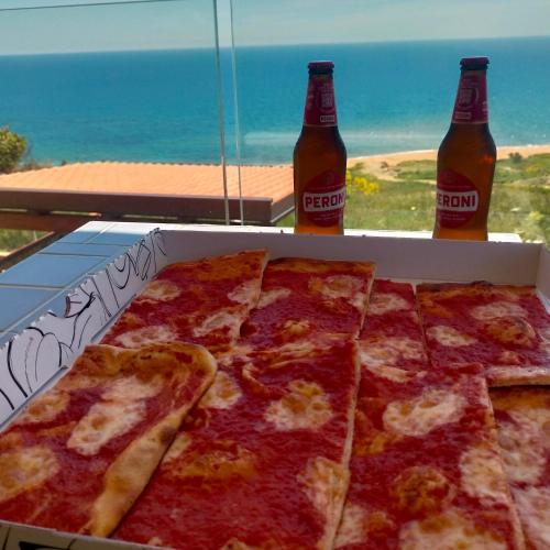 a box of pizza with two bottles of soda at Re Mare B&B in Crotone