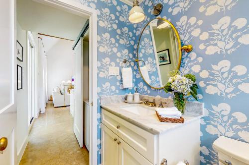 a bathroom with a sink and a mirror at Eco-Chic Lake Somerville Area Farmhouse w/ Porch in Brenham