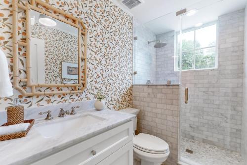 a bathroom with a sink and a toilet and a mirror at Off-Grid & Elegant Farmhouse Near Somerville Lake in Brenham