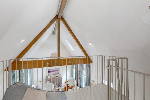 a staircase in a house with a white ceiling at Off-Grid & Elegant Farmhouse Near Somerville Lake in Brenham