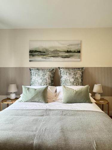 a bedroom with a large bed with two lamps at Island View - Spacious Two Bedroom Oban Apartment with Sea Views in Oban
