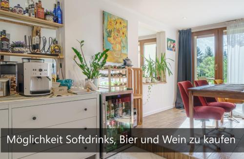 a kitchen with a table and a dining room at Ferienwohnungen Haselhuhn in Hartau