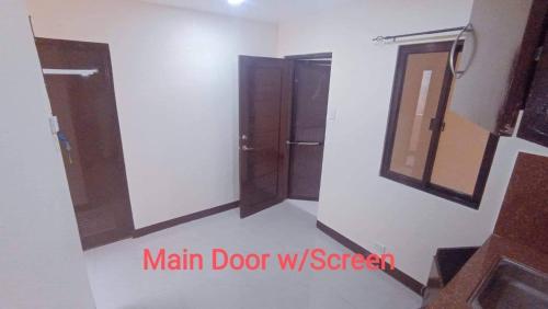 a room with three doors and a mirror at Parkdale apartment in Imus