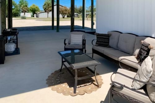 a living room with a couch and a glass table at Gulf Breeze Getaway in Saint Joe Beach