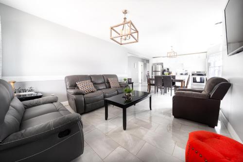 a living room with a couch and a table at Large-Group Ready 8BR Home Near Niagara Falls & Casino in Niagara Falls