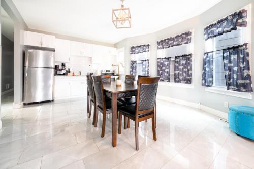 a kitchen and dining room with a table and chairs at Large-Group Ready 8BR Home Near Niagara Falls & Casino in Niagara Falls
