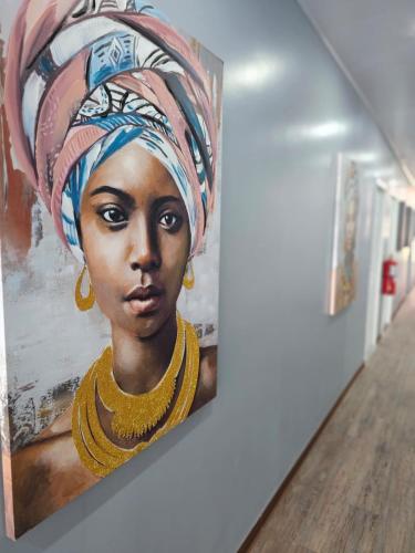 a painting of a woman with a turban on a wall at RESIDENCIAL LA MALVARROSA in Panama City