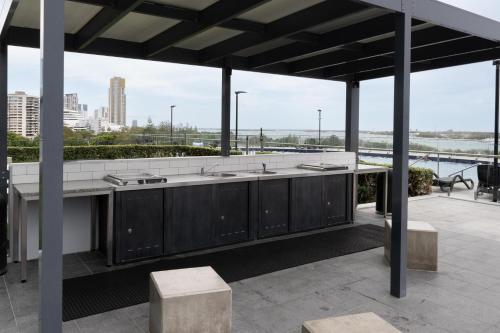 an outdoor kitchen with a view of the city at 703Mer in Gold Coast