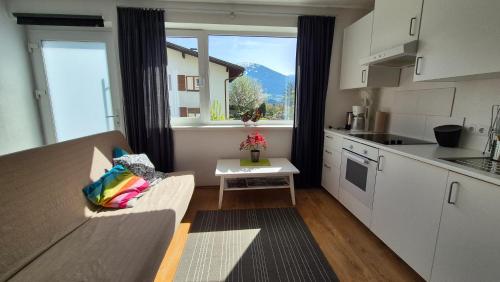 a kitchen with a couch and a table in a room at Studio Bike & Snow in Innsbruck
