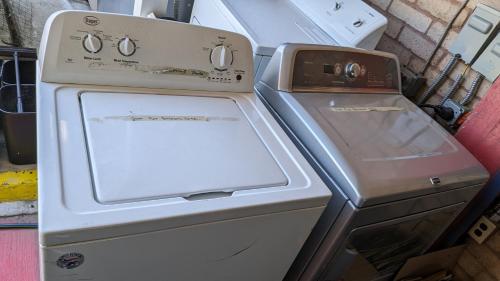 an old stove with an open door next to a refrigerator at Edelweiss Inn New Braunfels in New Braunfels