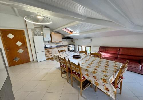 a kitchen and dining room with a table and a couch at Dimora Mariagrazia in Rimini