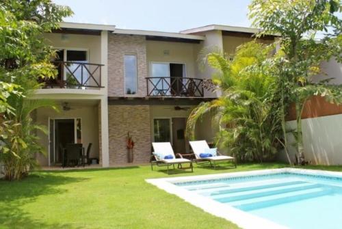 a villa with a swimming pool and a house at Escalonia 2 in Las Terrenas