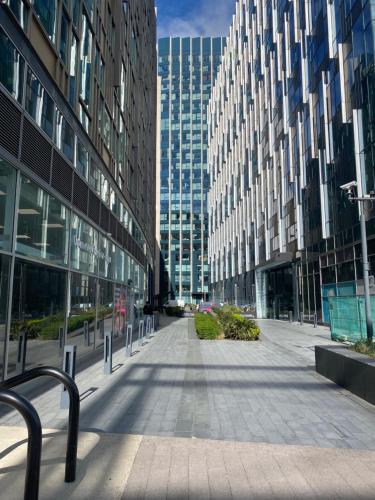 an empty street in a city with tall buildings at Luxury stay near O2 and canary wharf in London