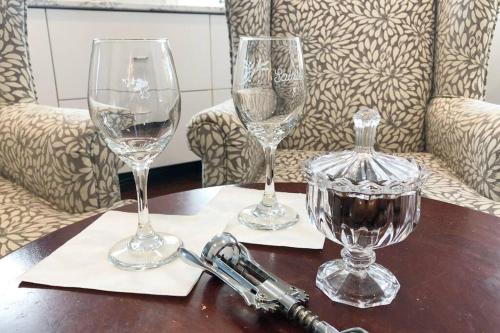 three wine glasses sitting on a wooden table at The Red House Fredericton in Fredericton