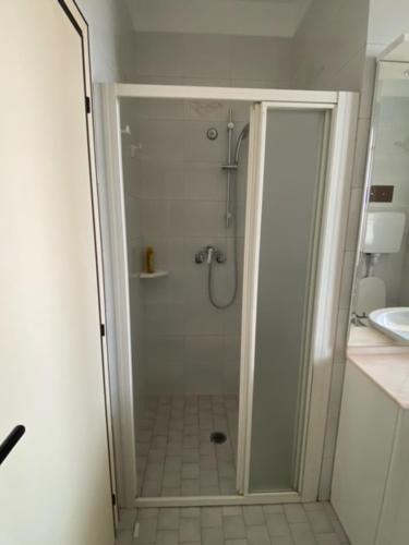 a shower with a glass door in a bathroom at Appena fuori in Misano Adriatico
