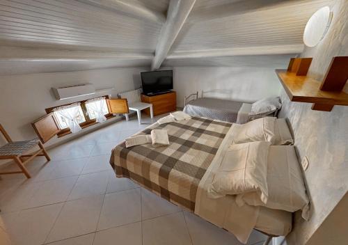 a bedroom with a bed and a tv in it at Dimora Mariagrazia in Rimini
