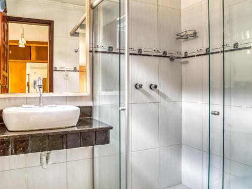 a bathroom with a sink and a shower at Hotel Park Stella Mares in Salvador