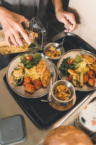 a table with plates of food on a tray at Okkar Inn in Nanwan