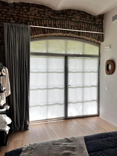 a bedroom with a large sliding glass door at Loft G Hospitality in Milan