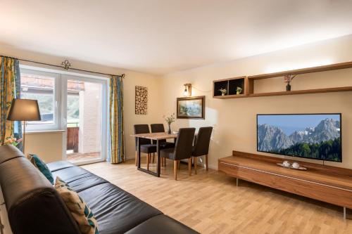 a living room with a couch and a table at Aktivurlaub, Wandern, Biken und Baden in Tirol, FeWo 13 in Thiersee