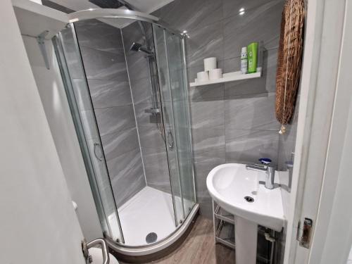 a bathroom with a shower and a sink at Impeccable 1-Bed Apartment in London in London