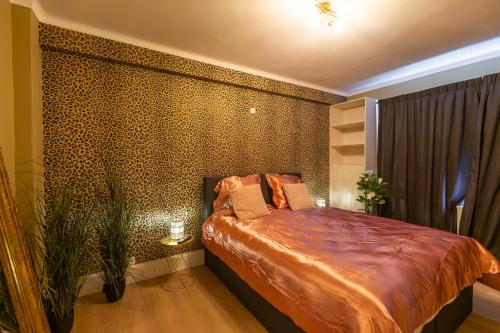a bedroom with a bed and a wall covered in dots at Appartement centrum 1 in Ostend