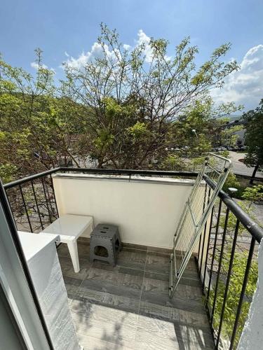 a balcony with a bench and a stair case at Apartman Centar in Kuršumlija