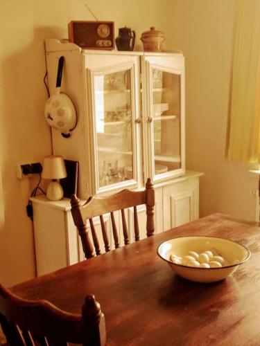 a dining room table with a bowl of food on it at Studniska Country Estate in Studniska