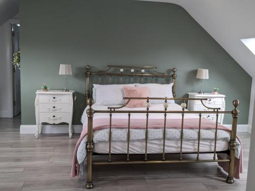 a bedroom with a bed and two night stands at Serenity Ballycastle in Ballycastle