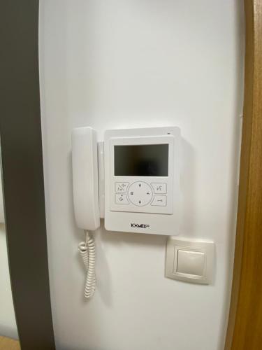 a phone is hanging on a wall at Lux Apartment Meecoon Rafailovići in Rafailovici