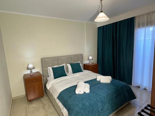 a bedroom with a bed with two towels on it at Eleni's Luxury Stay - Kos in Zipárion