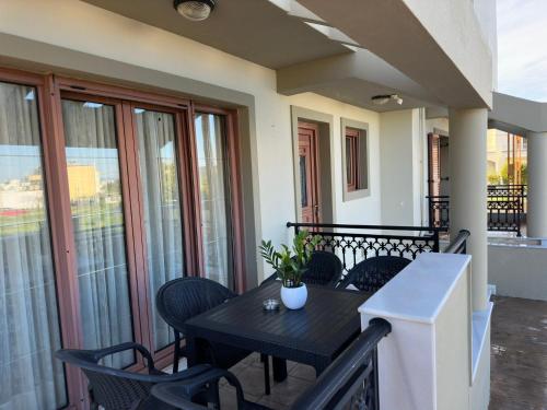 a black table and chairs on a balcony at Eleni's Luxury Stay - Kos in Zipárion
