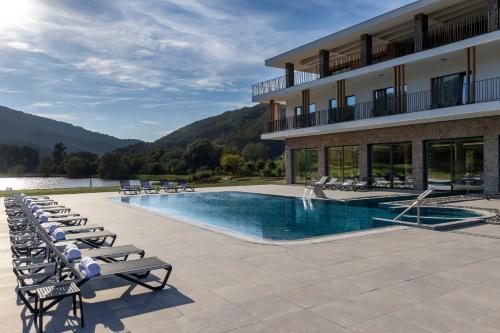 a hotel with a swimming pool and lounge chairs at Hotel Biogor Wellness & Spa in Sisevac